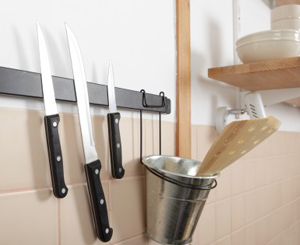 an organized kitchen features a wall mounted knife magnet 