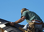 a skilled craftsman installs composite shingles
